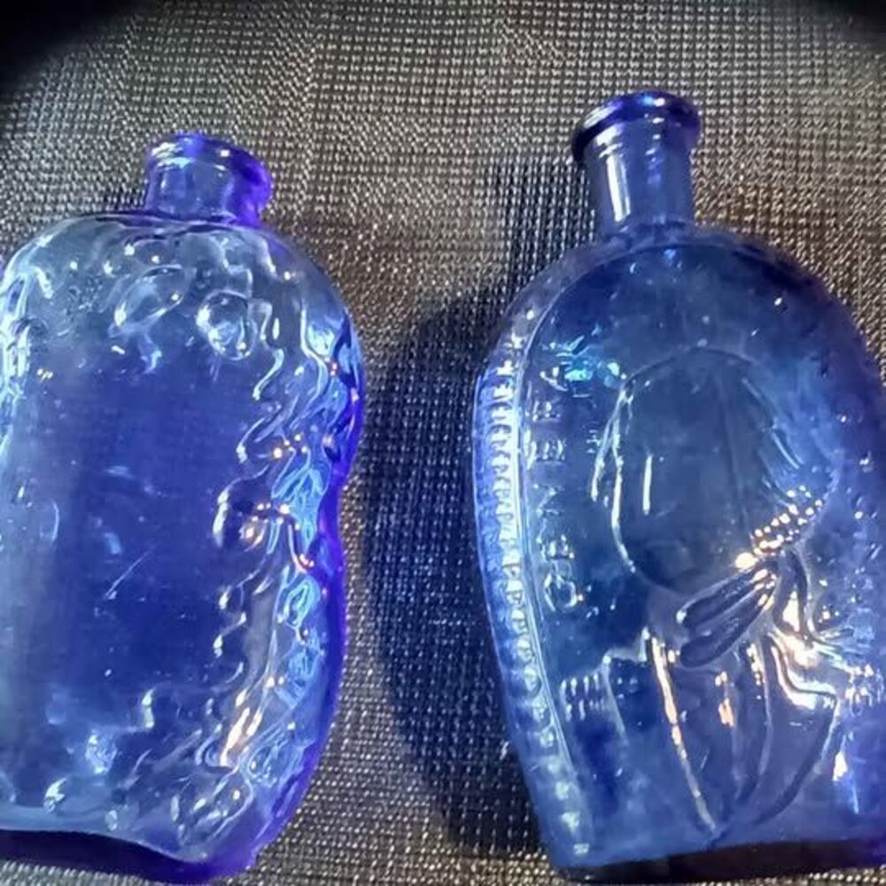 Set of 2 vintage cobalt blue embossed glass flasks